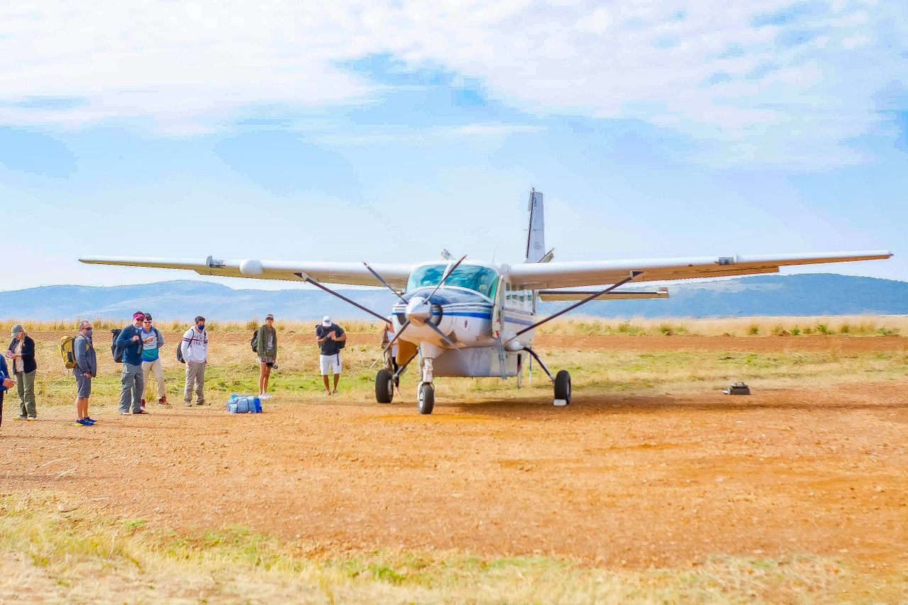 HHM Wildlife Safaris guide leading guests through the Tanzanian bush